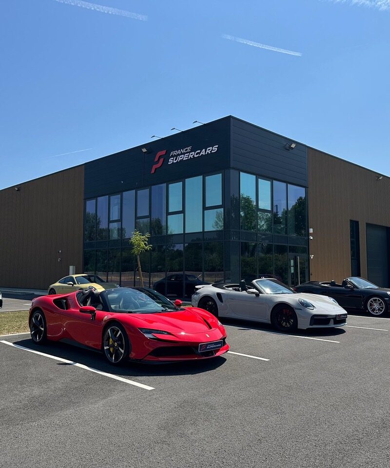 Luxury sports cars parked outside the France Supercars showroom in Lyon on a sunny day